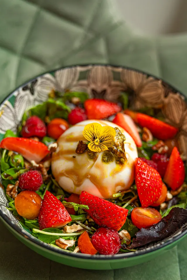 A salad with vegetables and cheese.