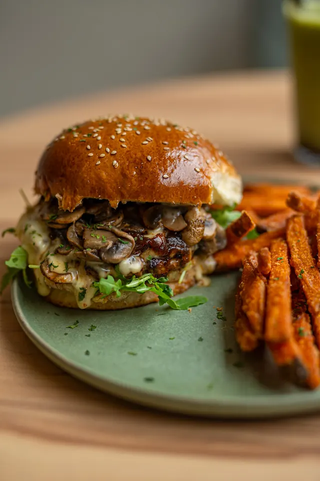 A burger served with potato wedges.